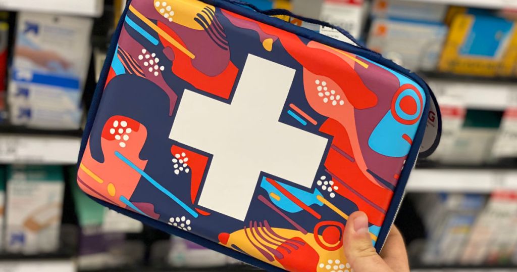 hand holding multi-colored first aid kit 