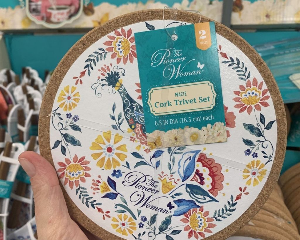 hand holding The Pioneer Woman Trivet Set in store