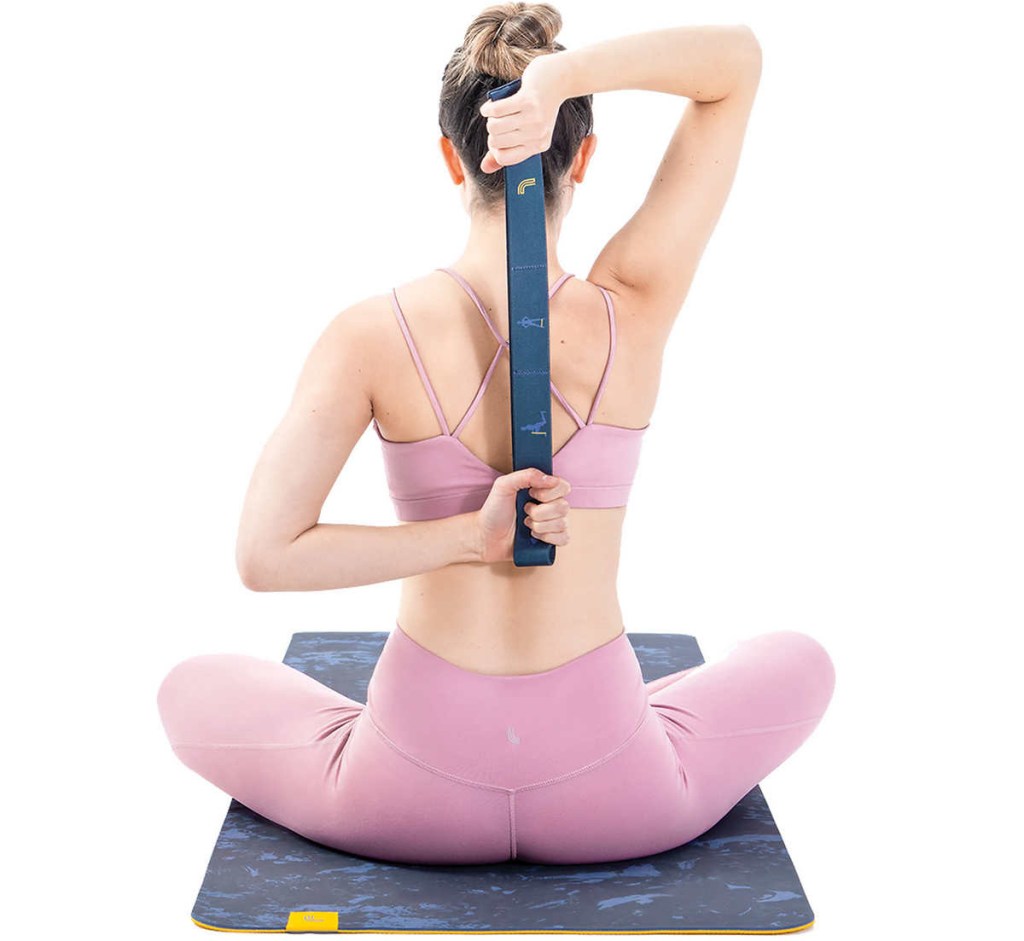 Woman using a resistance band on a yoga mat