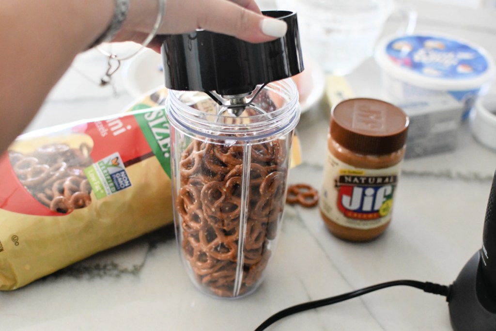 adding mini pretzels to blender