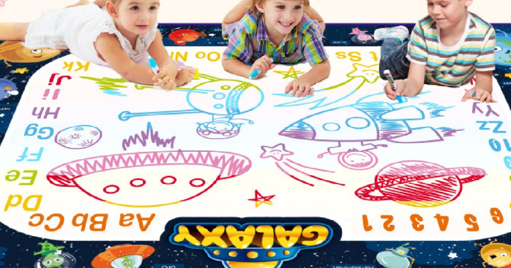 large mat with three kids drawing on it