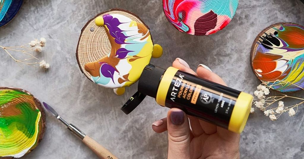 hand holding yellow Arteza paint