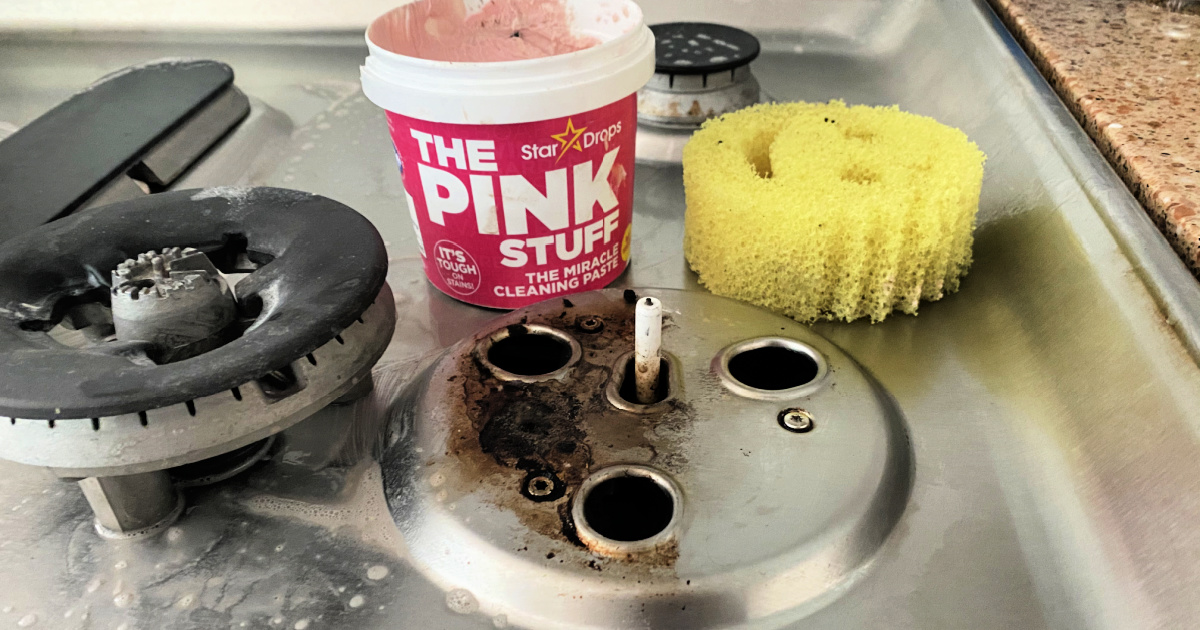 cleaning the stove top with the pink cleaner