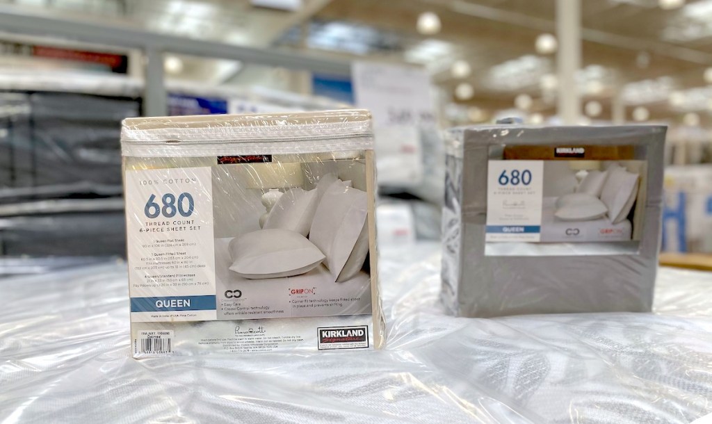 two packages of bed sheets on display in store