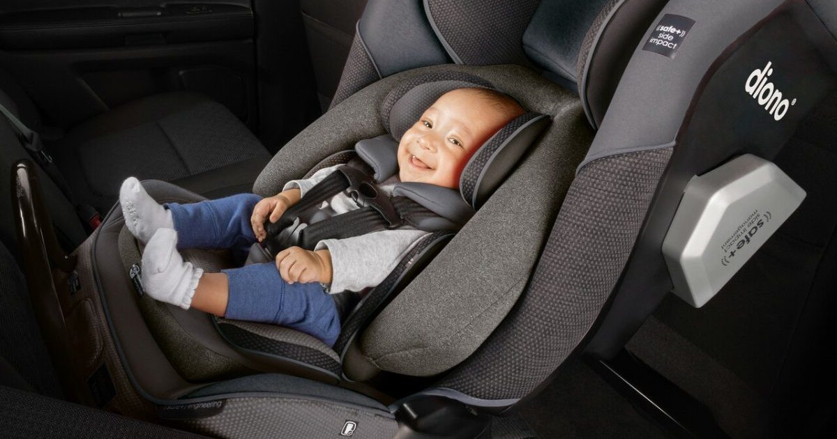 baby sitting in carseat inside car