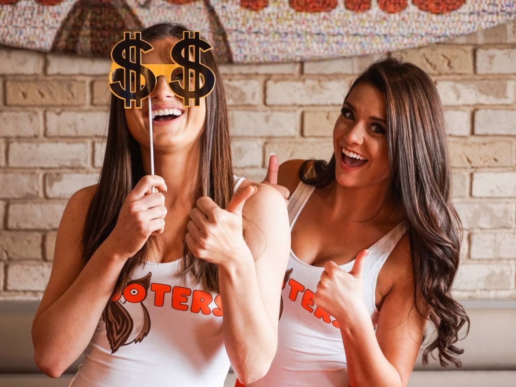 Hooters servers with dollar sign photo booth prop
