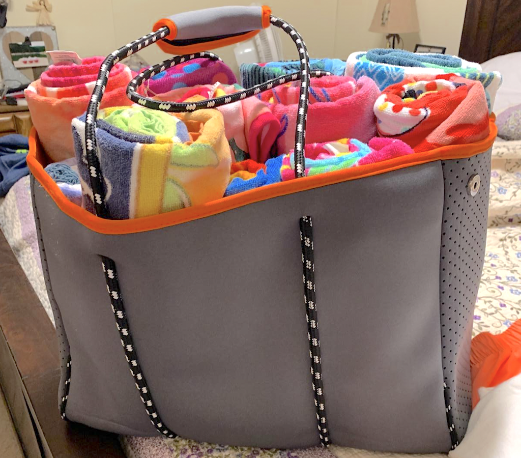 large beach tote filled with towels 