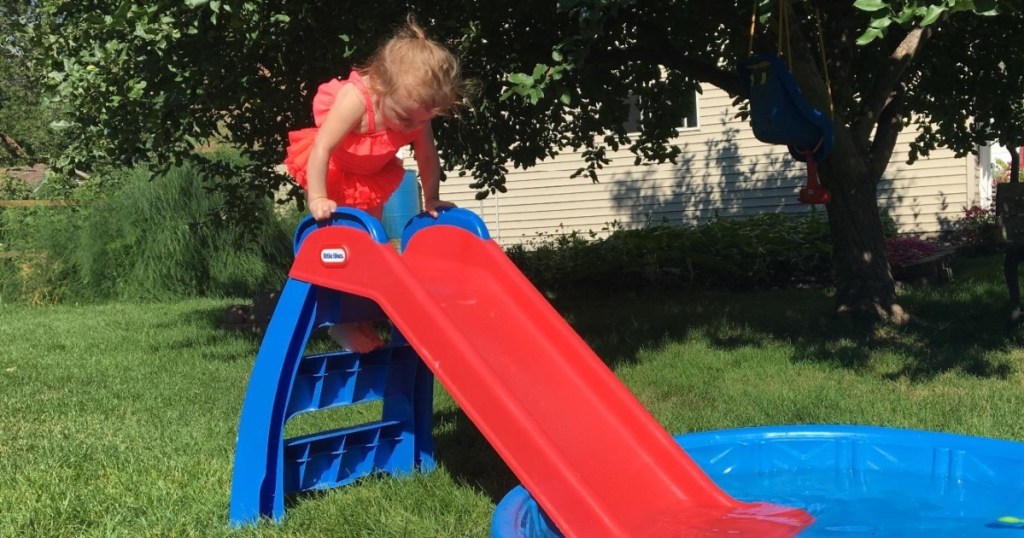 girl climbing up toddler slide