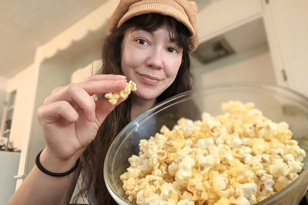 woman holding kernel of popcorn