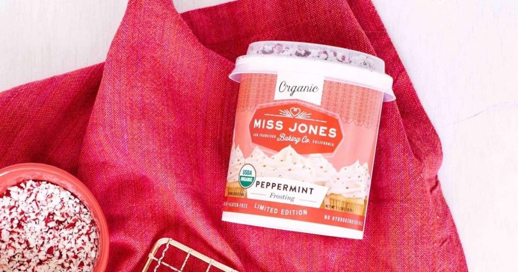 Miss Jones frosting can laying on red cloth