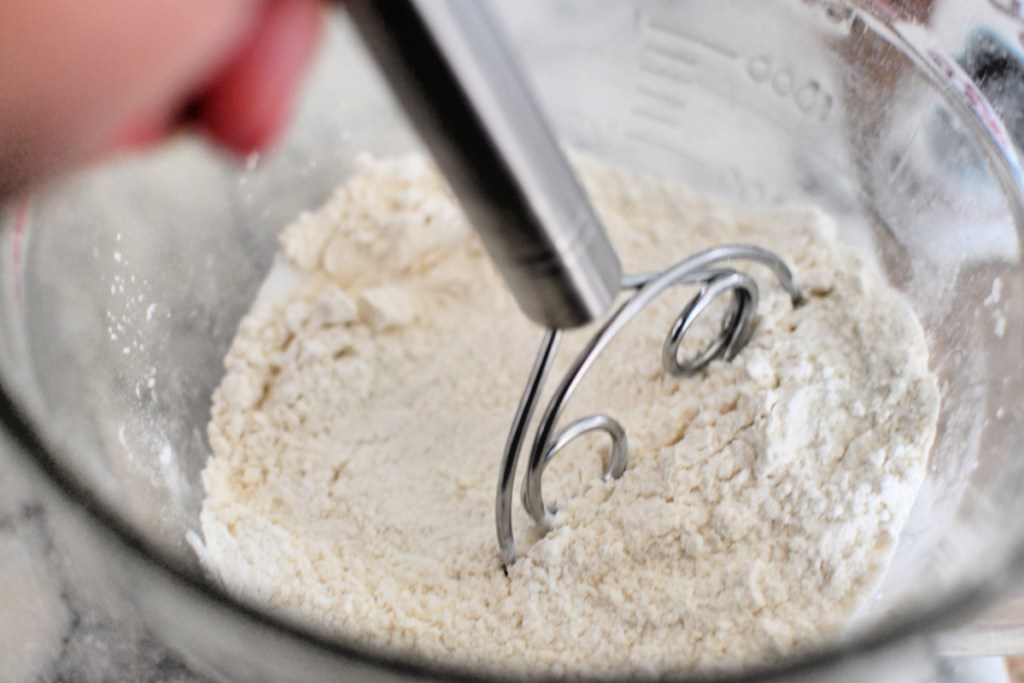 mixing dry ingredients for homemade pancakes using danish whisk 