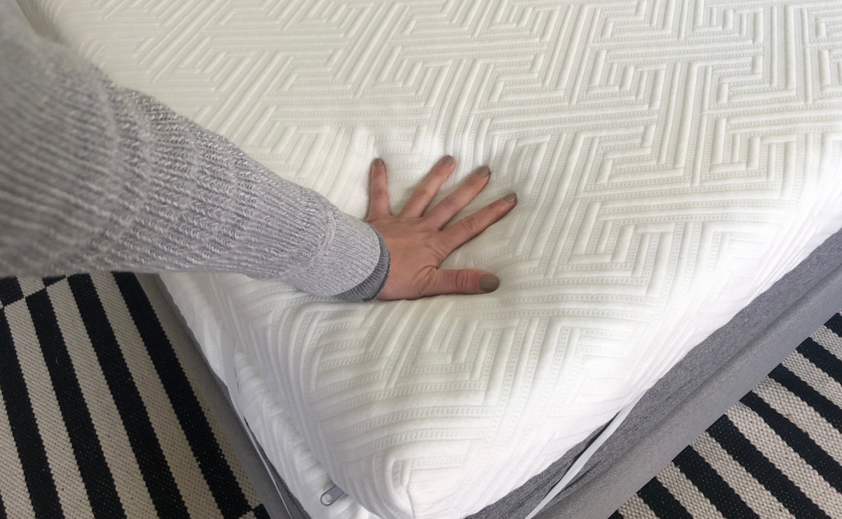 hand touching mattress