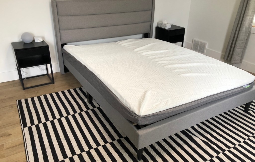 unrolled mattress on bedframe