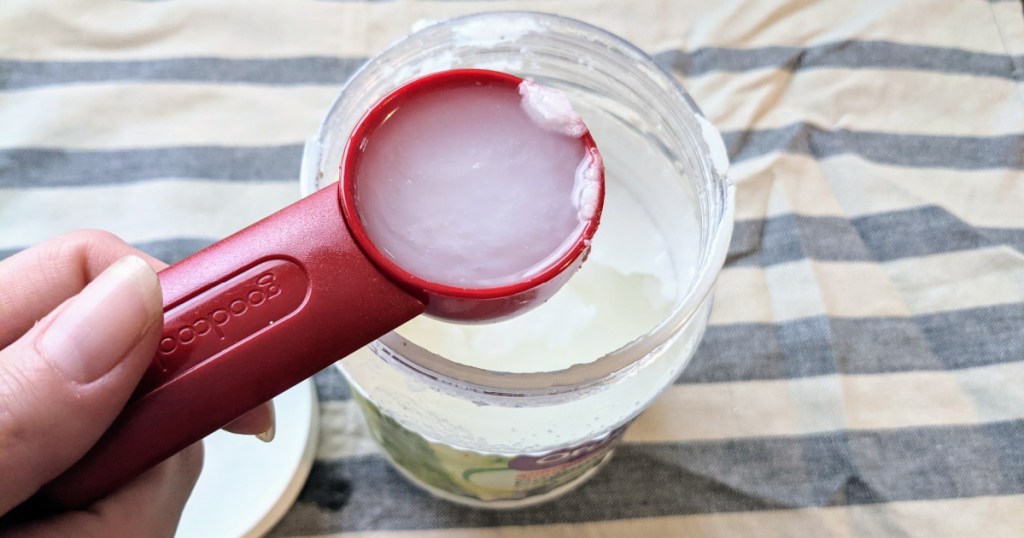 tablespoon and open container of coconut oil