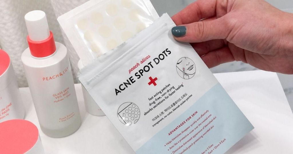 hand holding opened Acne Spot Dots packages