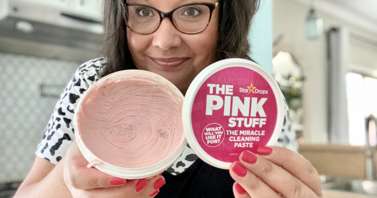 woman holding pink stuff cleaning paste 
