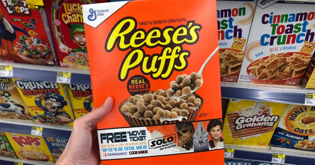 reeses puffs cereal box in hand