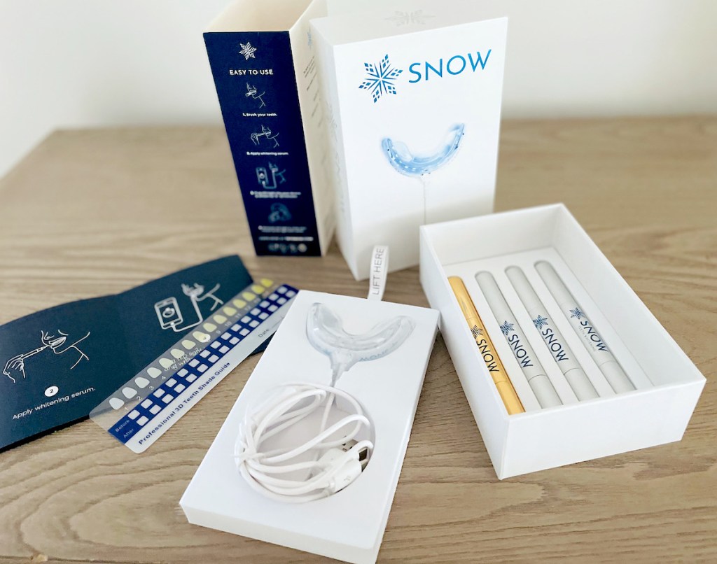 snow teeth whitening kit spread out on wood table