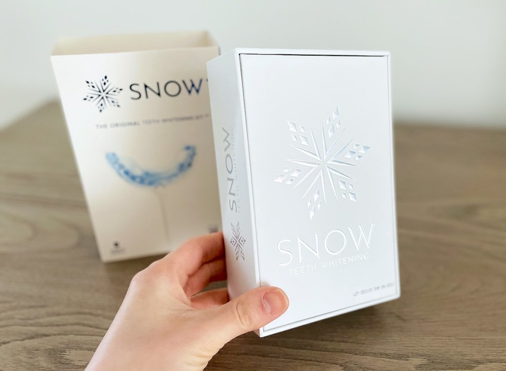 hand holding snow teeth whitening kit box