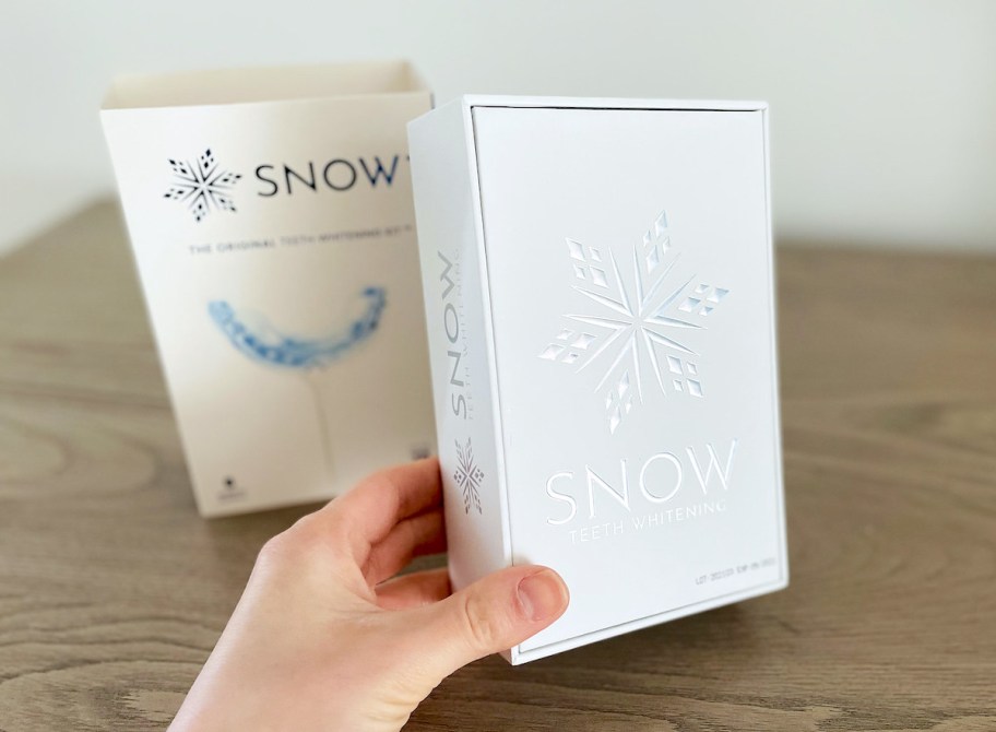 hand holding snow teeth whitening kit box