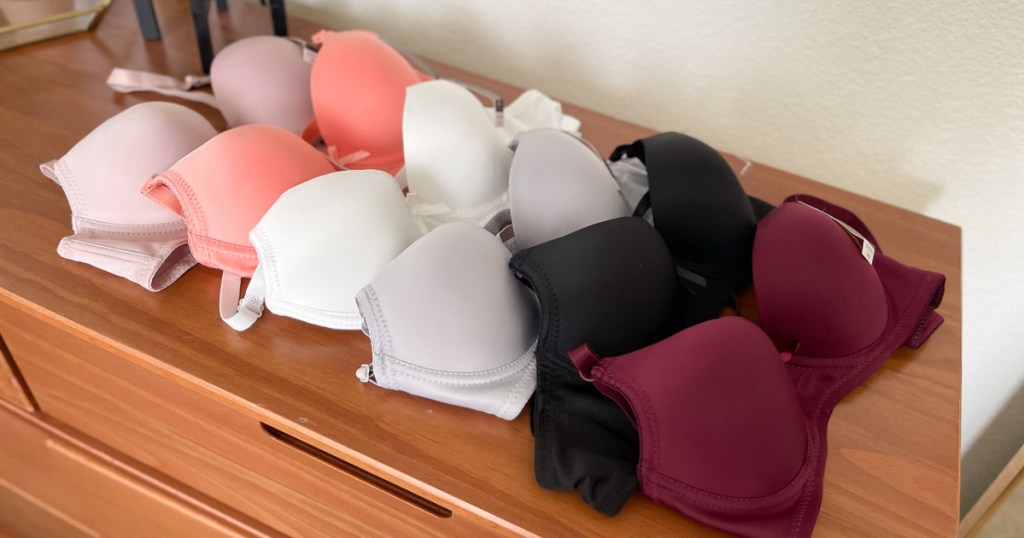 six different colored bras on a dresser