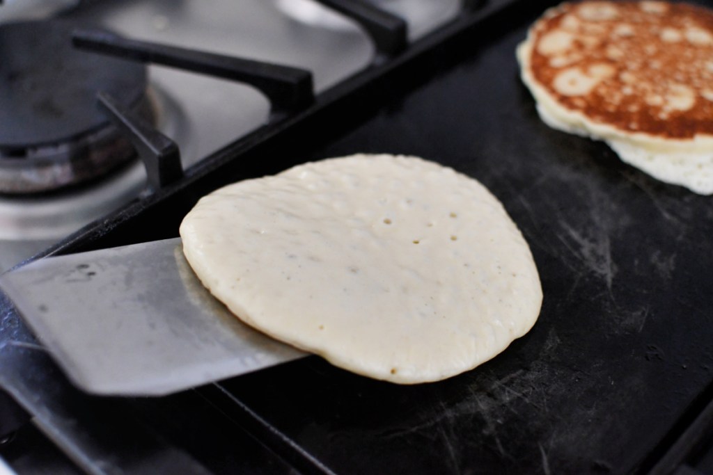 turning pancakes over on the griddle