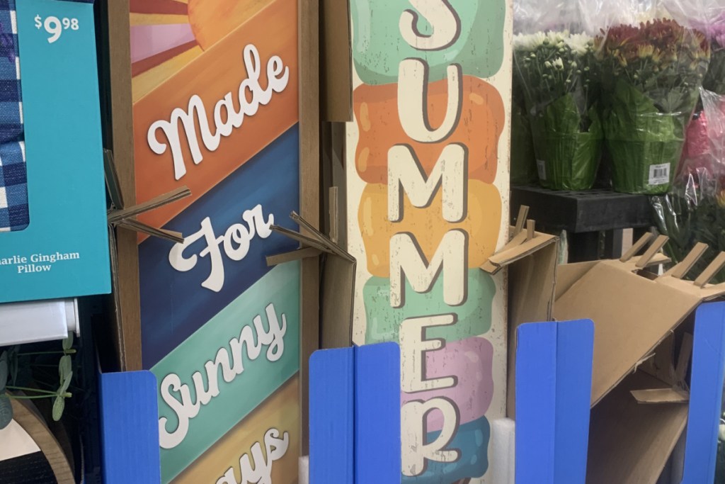 colorful summer signs in blue box on shelf