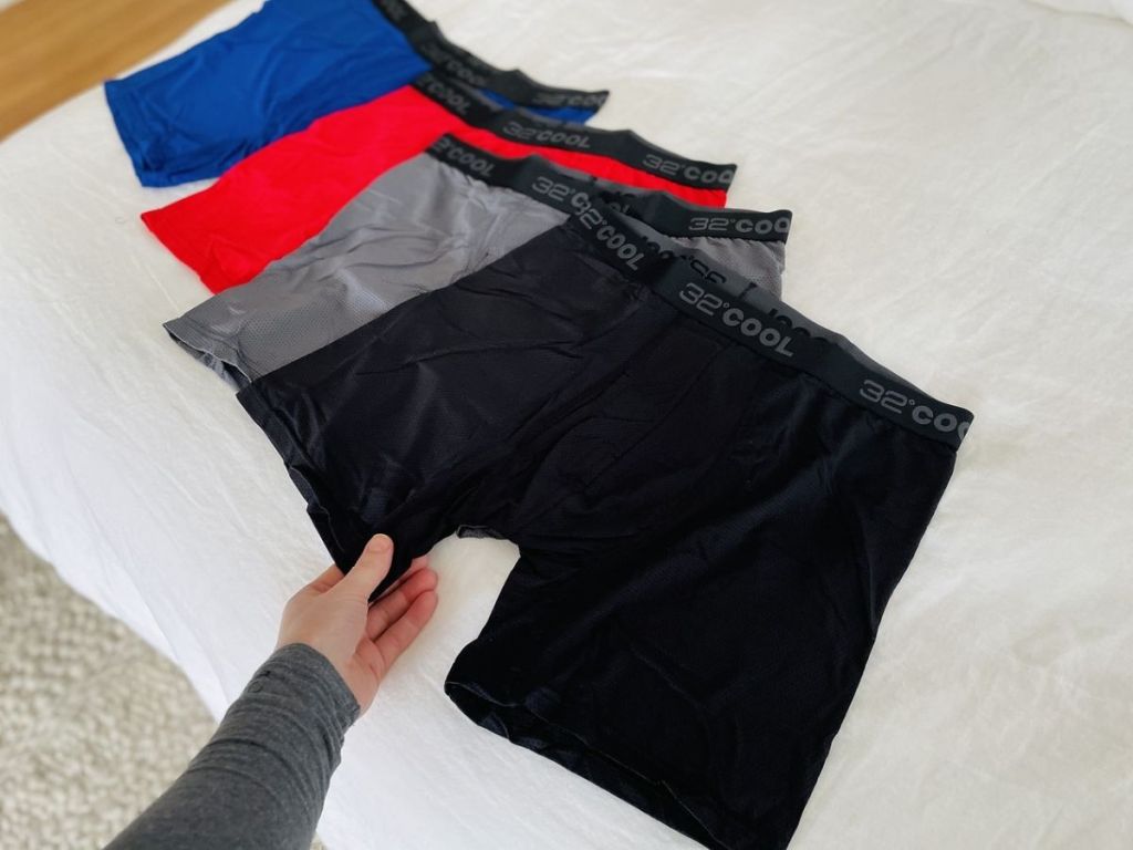four pairs of men's boxer briefs on bed
