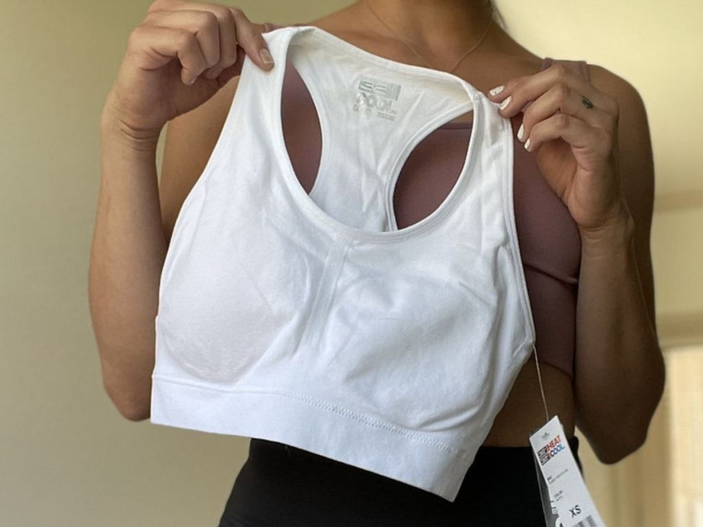 woman holding up a sports bra