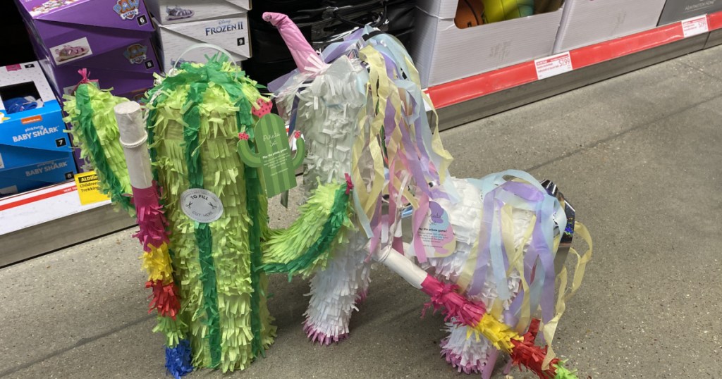 two styles of pinatas on a store floor