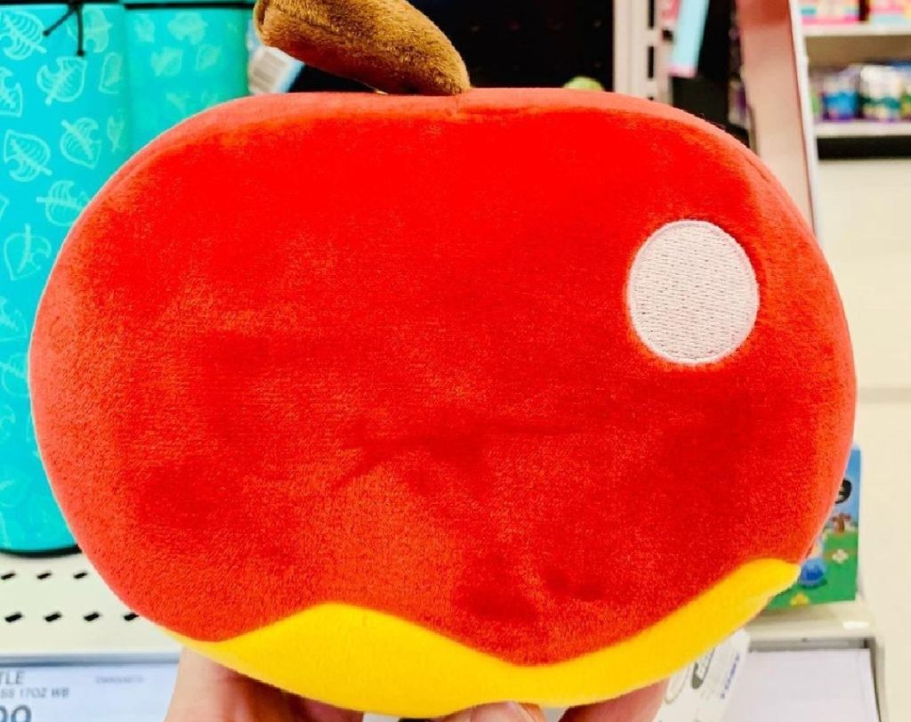 hand holding video game apple character plush in store