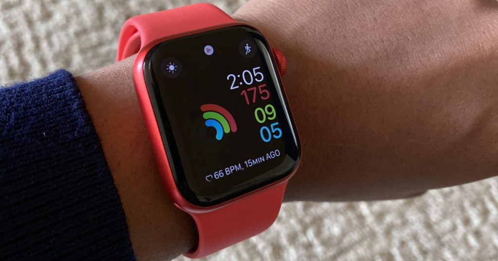 red smart watch on person's wrist