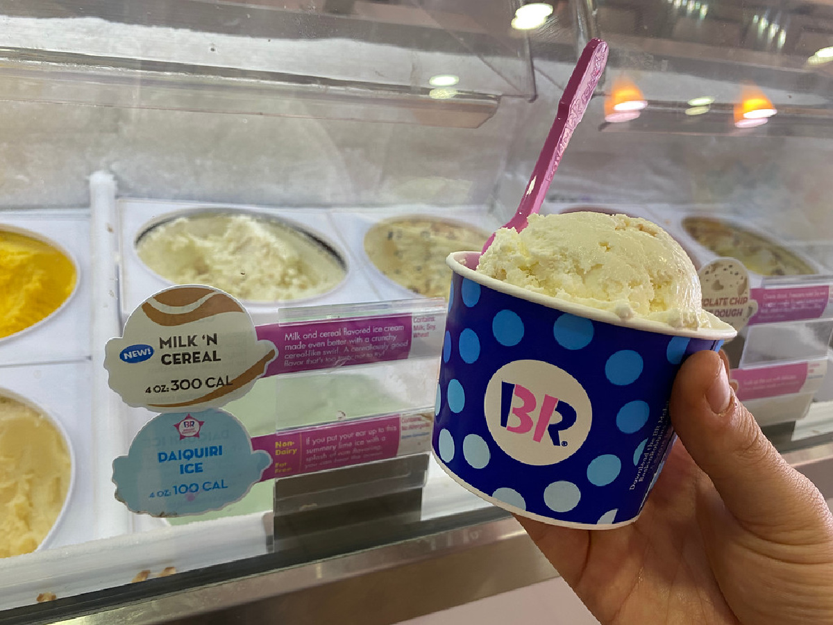 holding scoop of ice cream in baskin robbins cup
