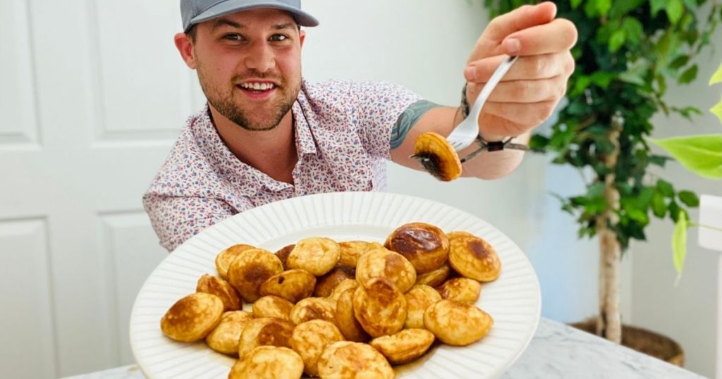 man holding a mini pancake on a fork