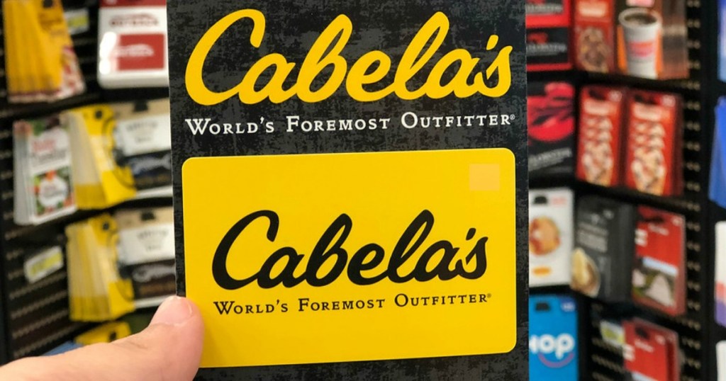hand holding a Cabela's gift card