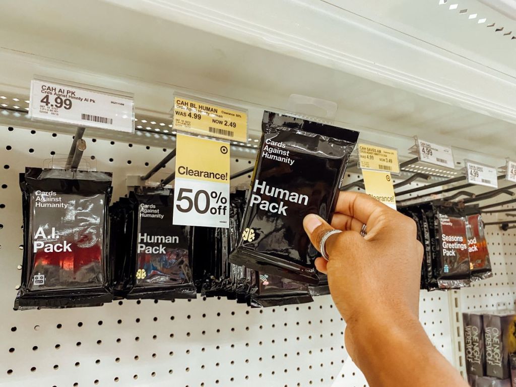 hand holding a Cards Against Humanity Human Pack