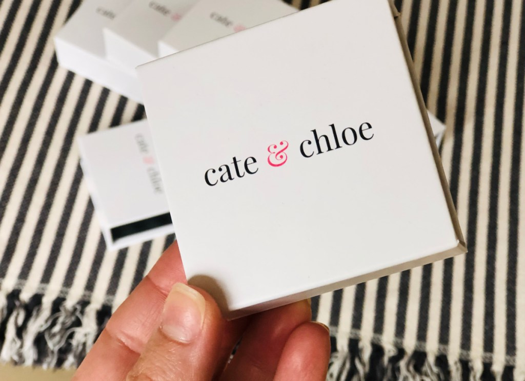 hand holding cate & chloe jewelry box