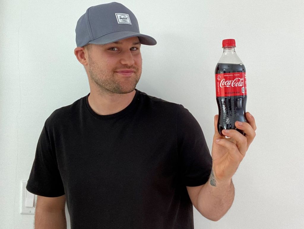 man holding a Coke