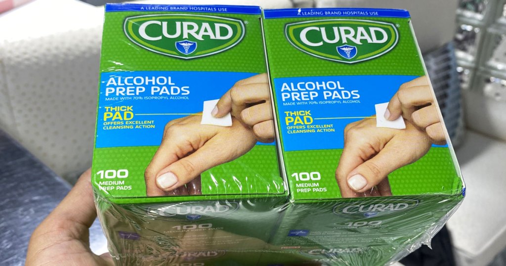 hand holding box of curad alcohol prep pads