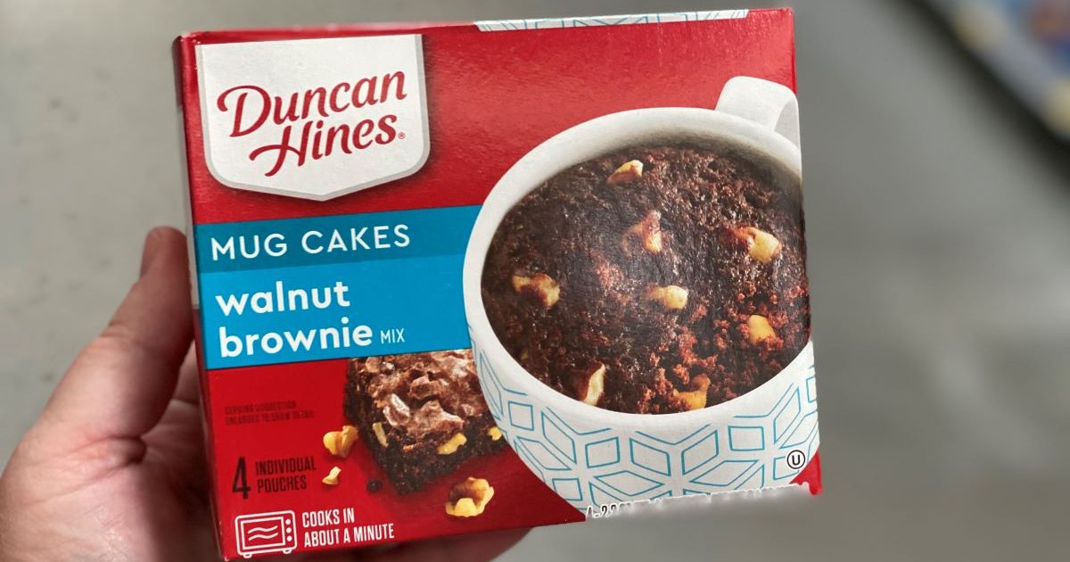 hand holding a Duncan Hines Walnut Brownie Mug Cake box