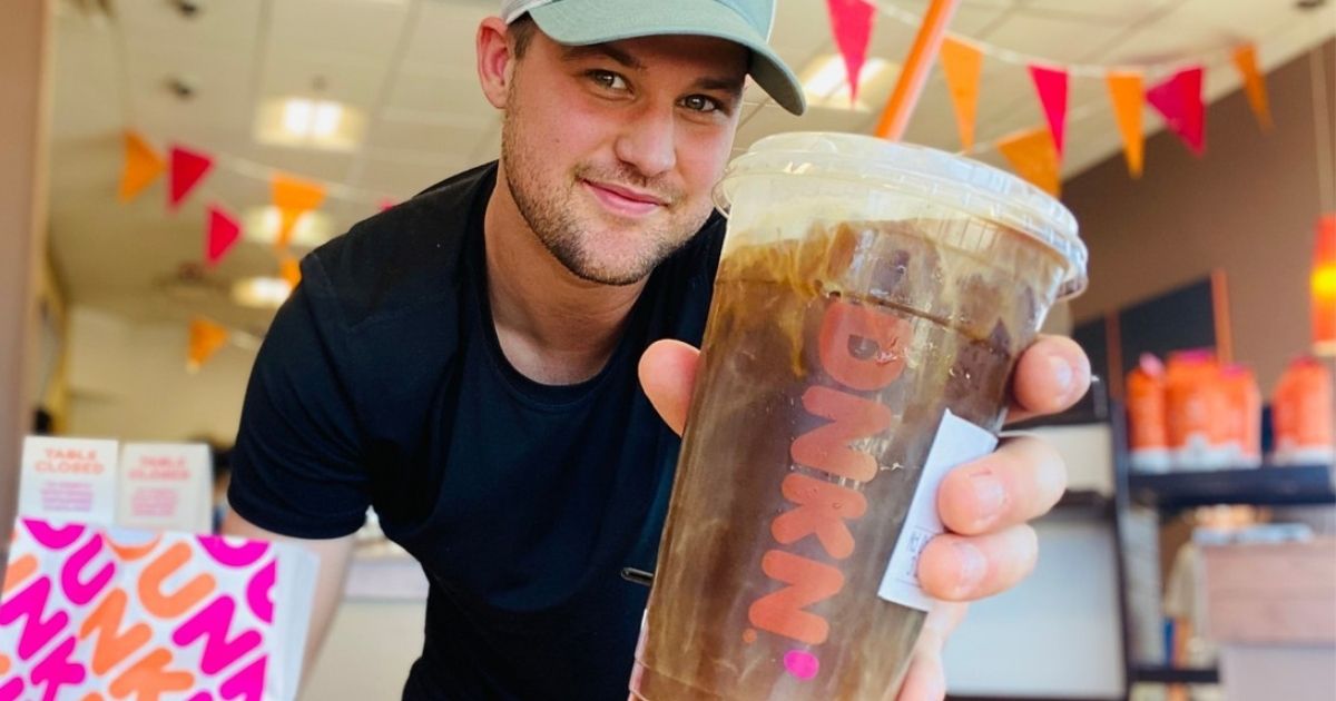 man holding a dunkin donuts cold brew