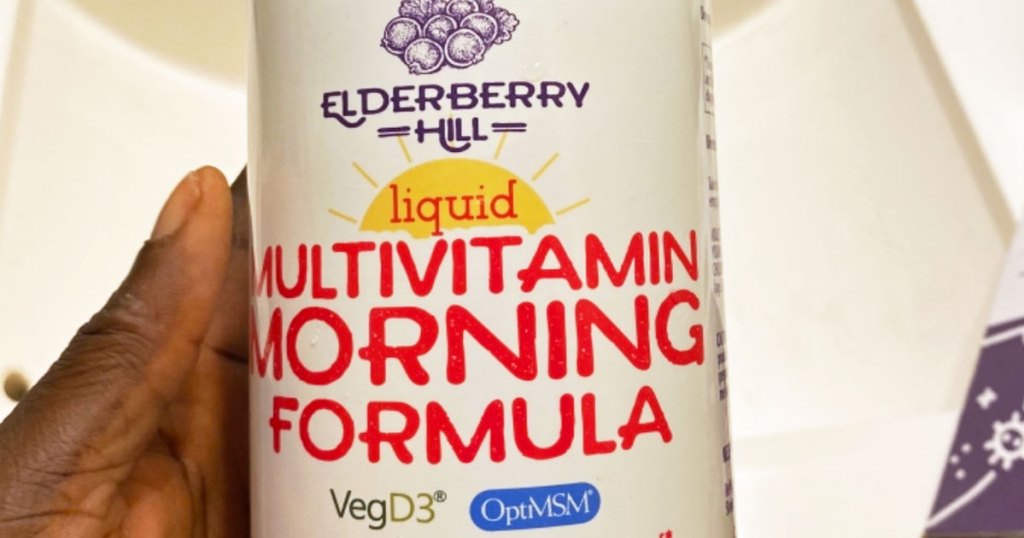 holding bottle of elderberry hill multivitamin