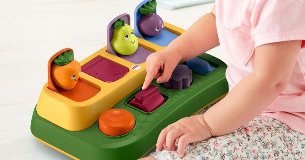 baby playing with Fisher Price Tiny Garden Pop up Surprise