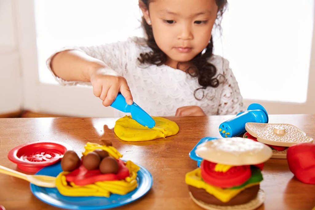 girl playing with a dough set