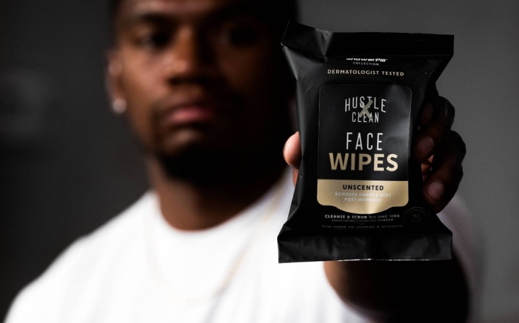 man holding pack of face wipes