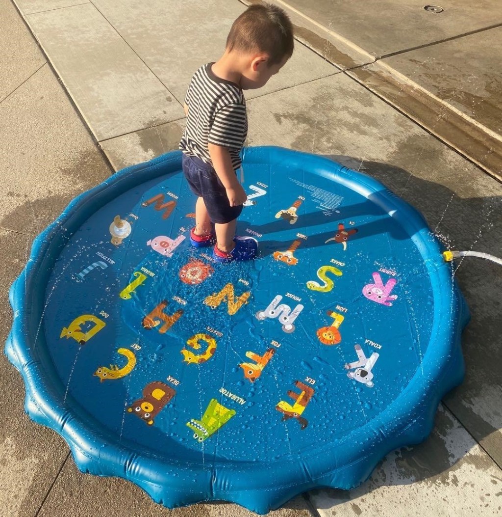 boy standing on a splash pad