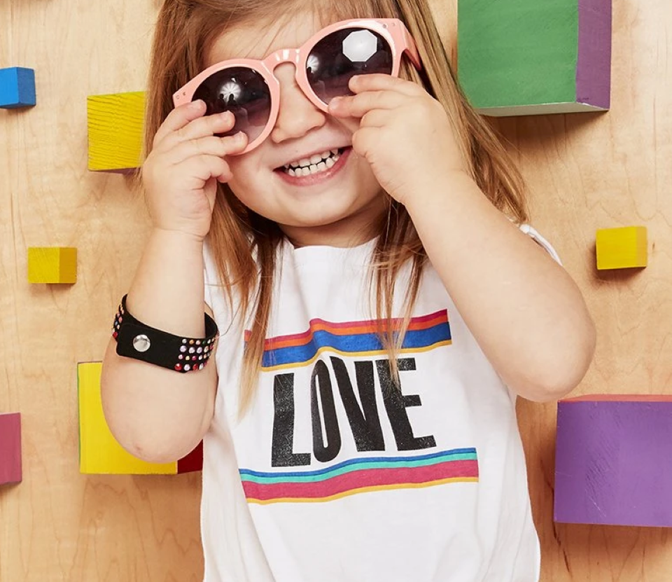 toddler girl holding her sunglasses