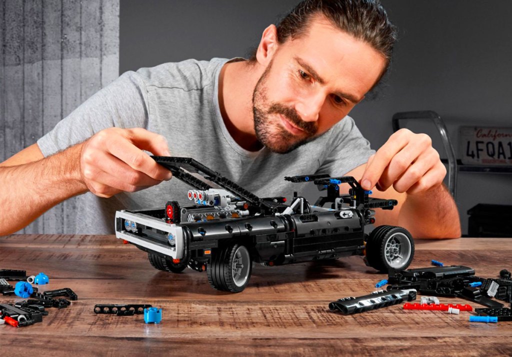 man building a lego dodge charger