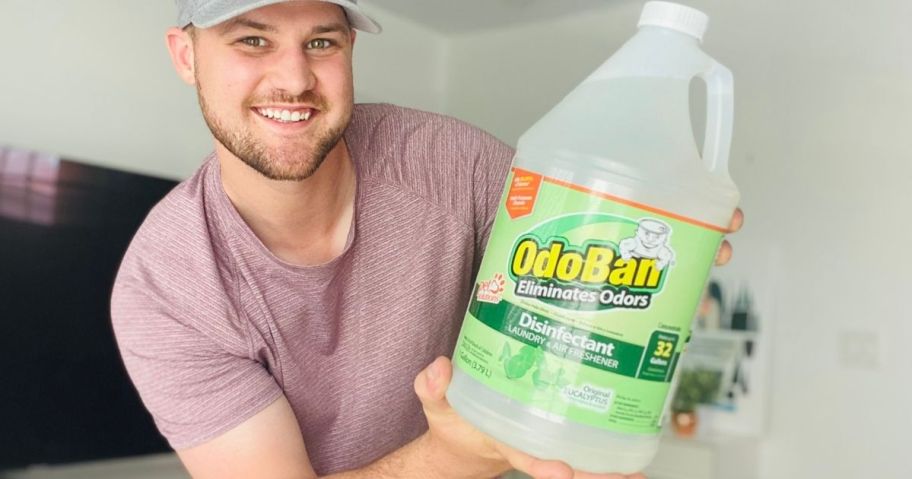 man holding a gallon of Odoban