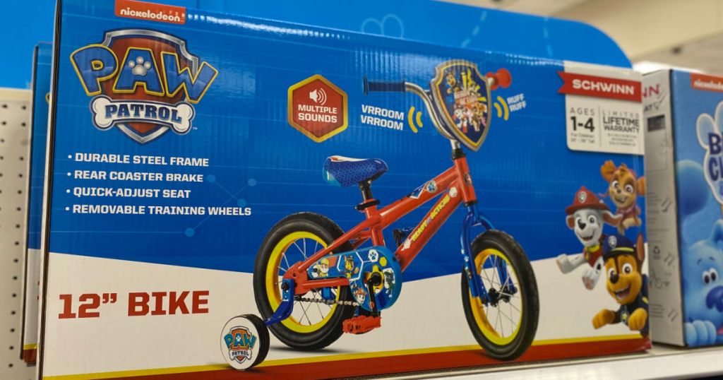 blue box with kids bike on shelf 